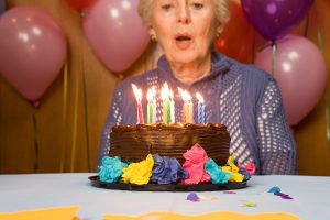 Woman Blowing Out Candles